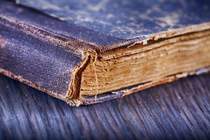 Old book over wooden table